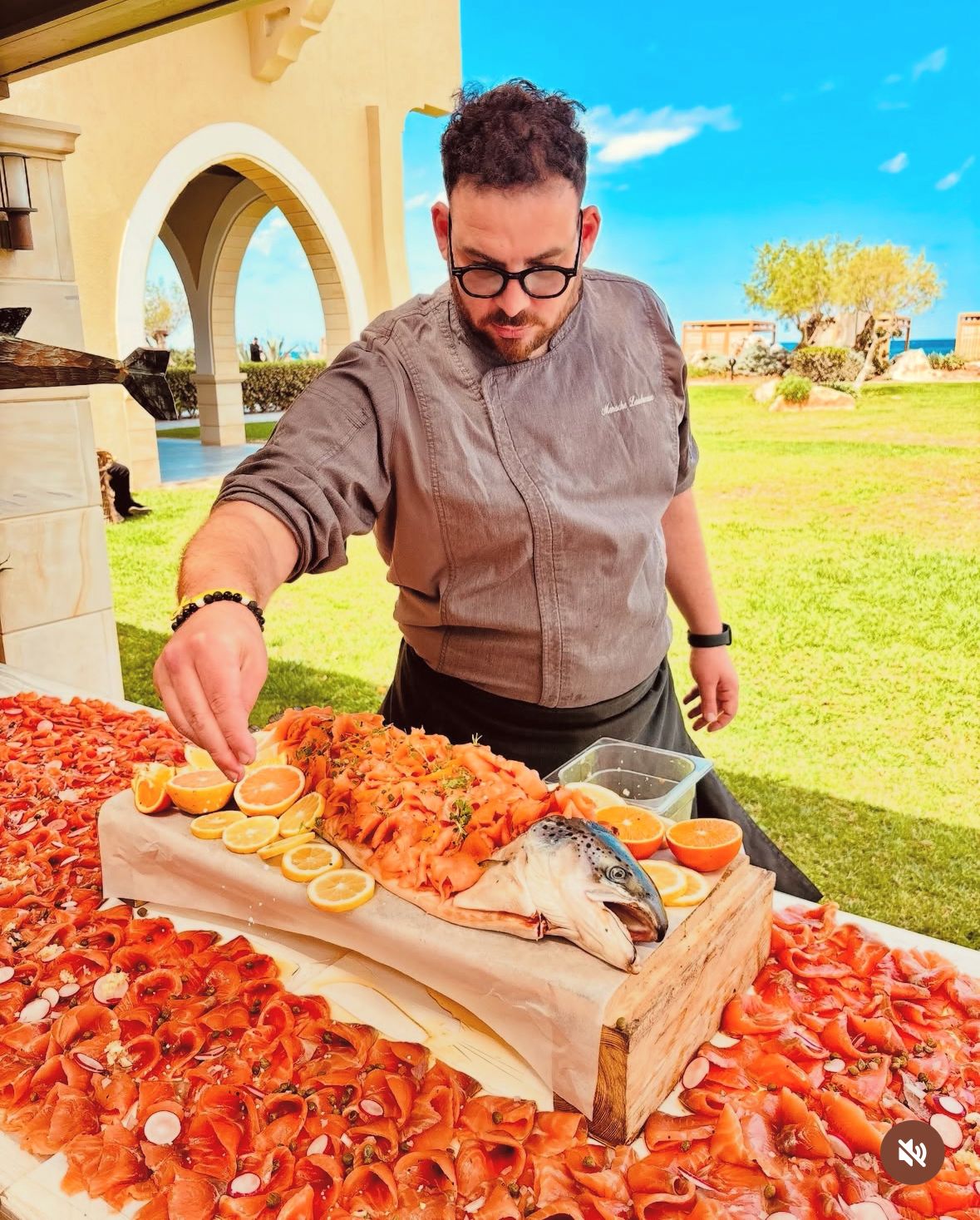 Chef Menaché finishing a seaside salmon banquet in the Mediterranean sun